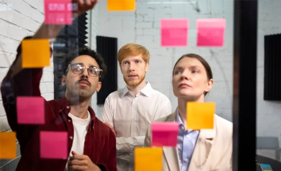 Medium shot people looking at post its