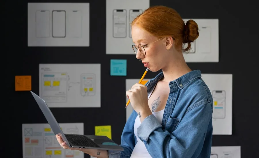 Female designer in the office with laptop